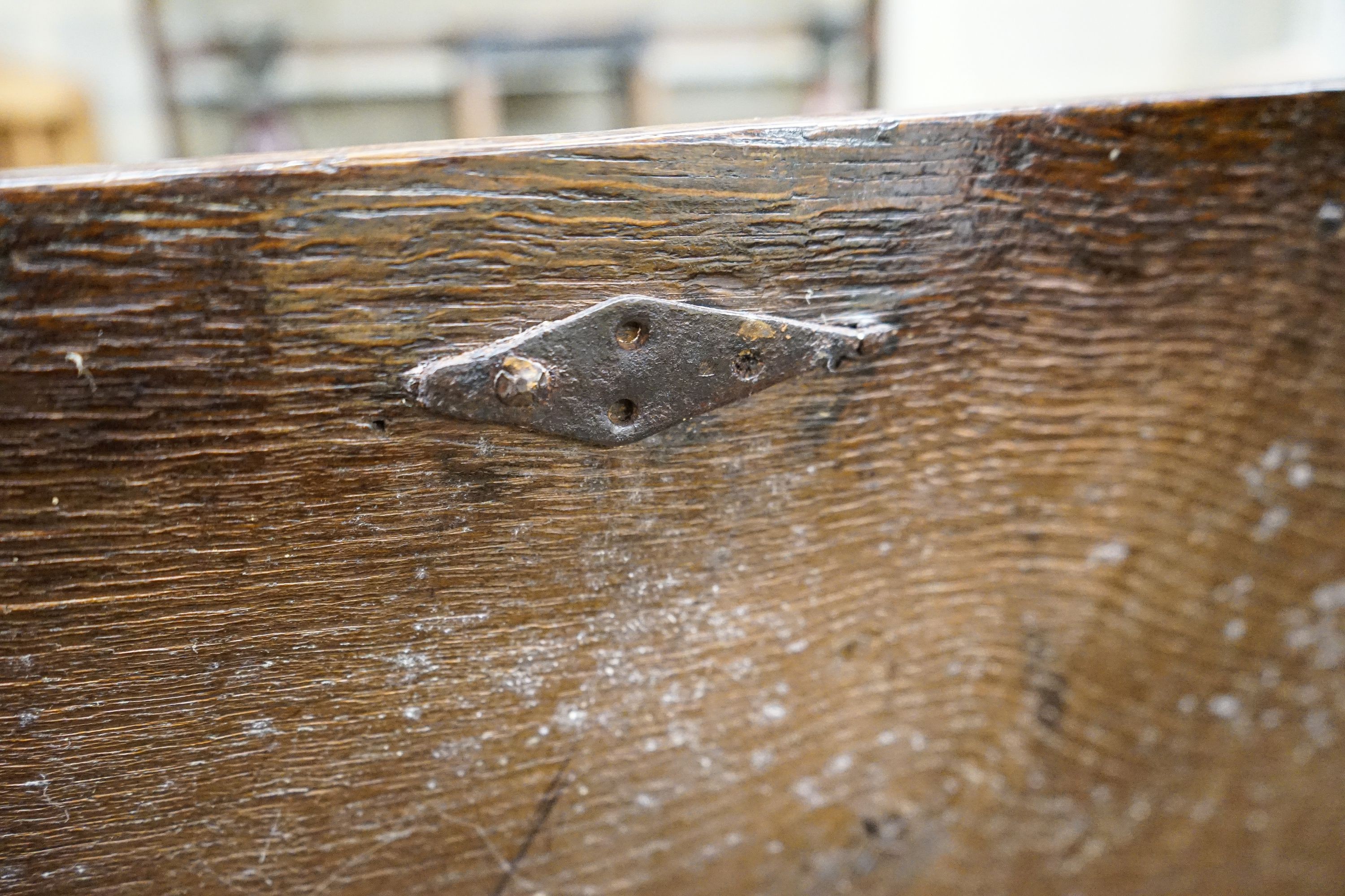 A 17th century oak coffer, with later carved front, length 120cm, depth 56cm, height 69cm